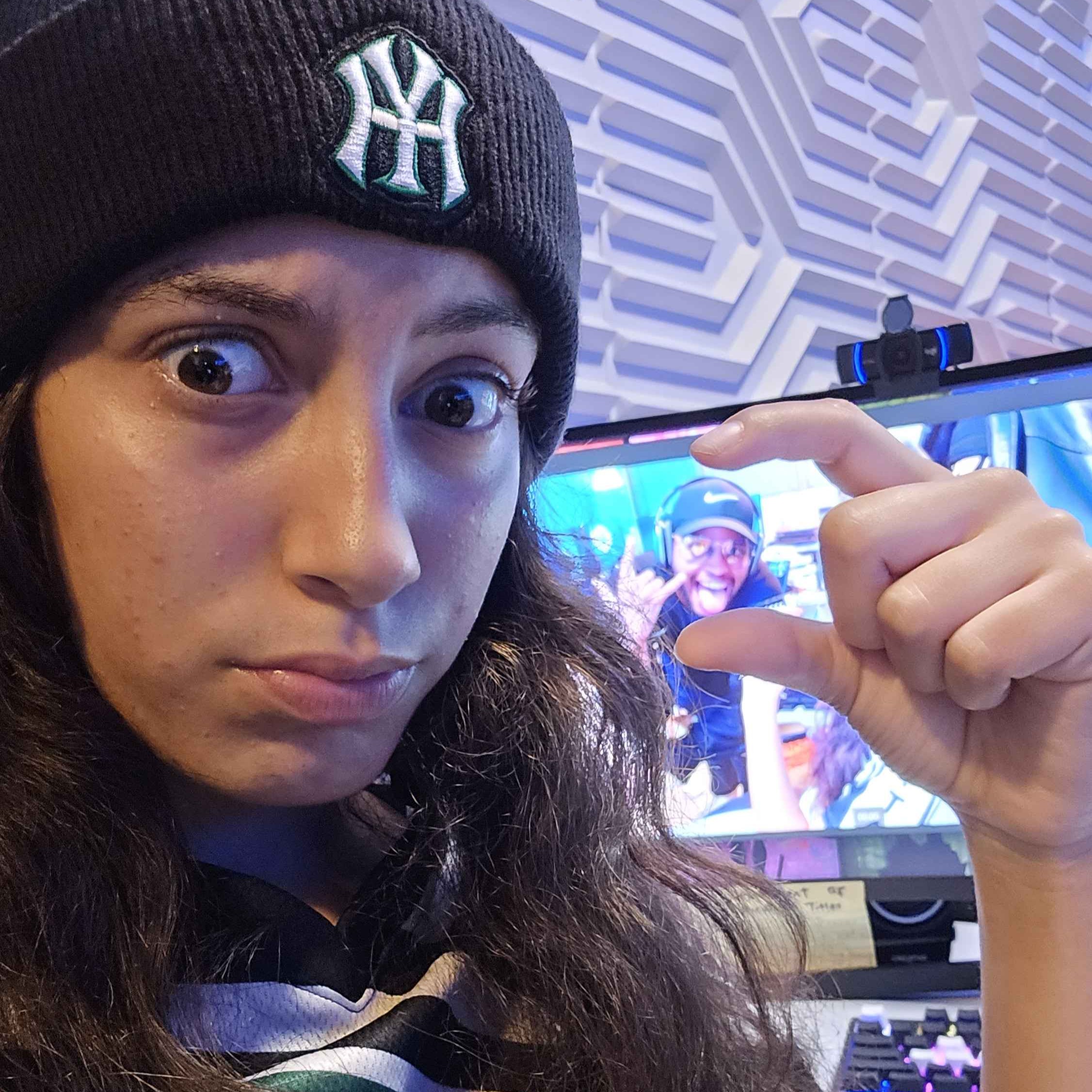 Student selfie with the coach in the background